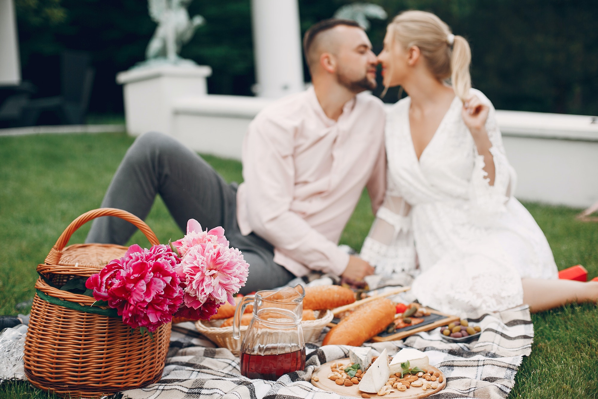 Beautiful couple spend time in a summer garden